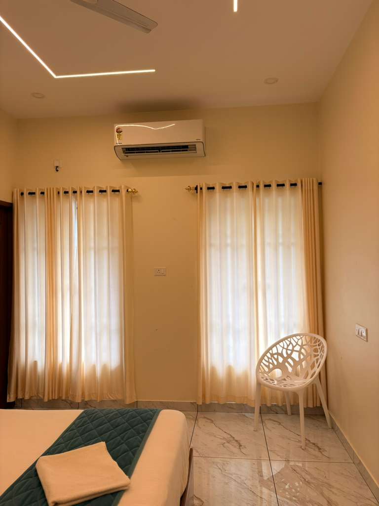 AC Executive Room interior with warm wood headboard